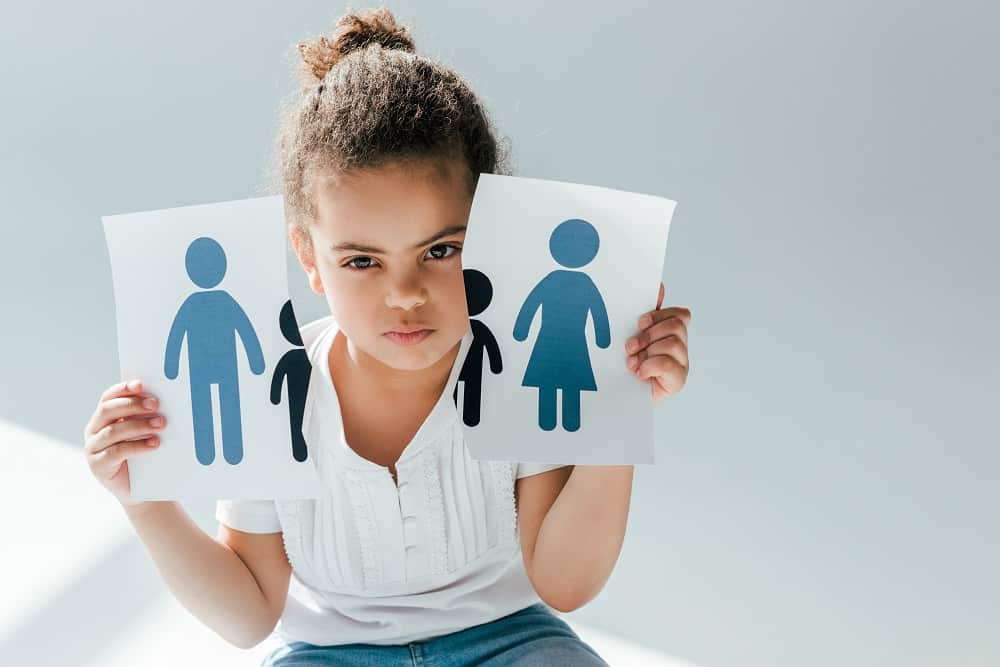 african american child holding ripped paper with family on white, divorce concept