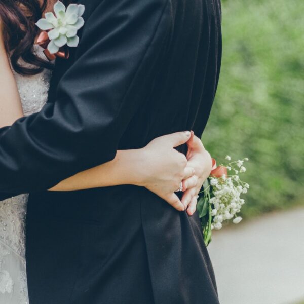 Bride hugging a person in a tuxedo | New Direction Family Law