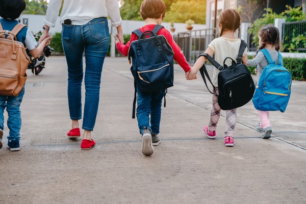 Children holding hands as they walk | New Direction Family Law