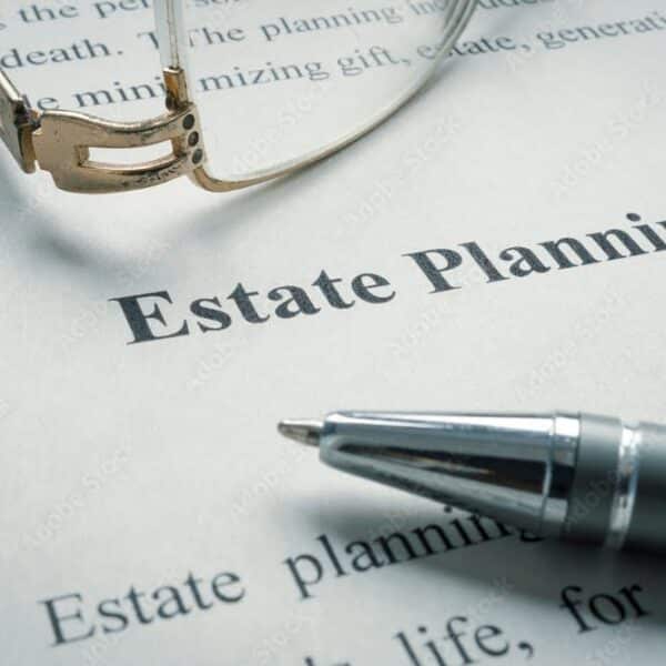 Estate planning document with a pen and glasses laid on top.