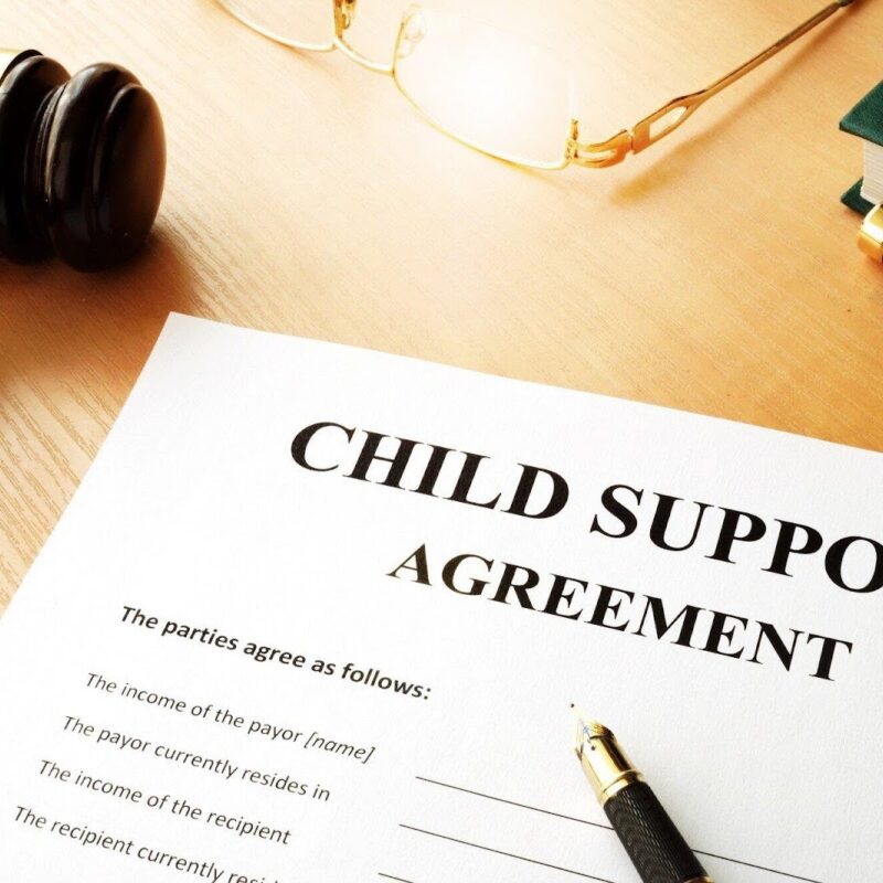 View of child support agreement with pencil to sign. | New Direction Family Law