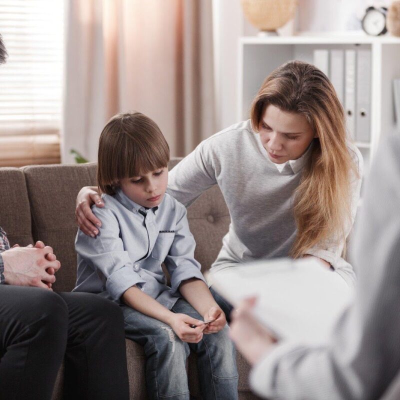 Young child being consoled by mom and dad. | New Direction Family Law