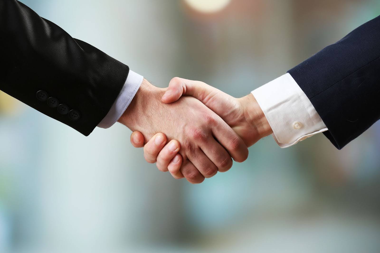 Business professionals shaking hands. | New Direction Family Law