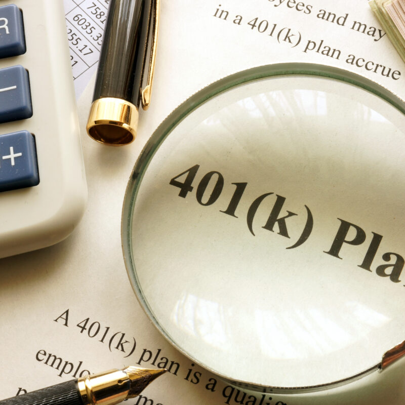 401k document under magnifying glass.