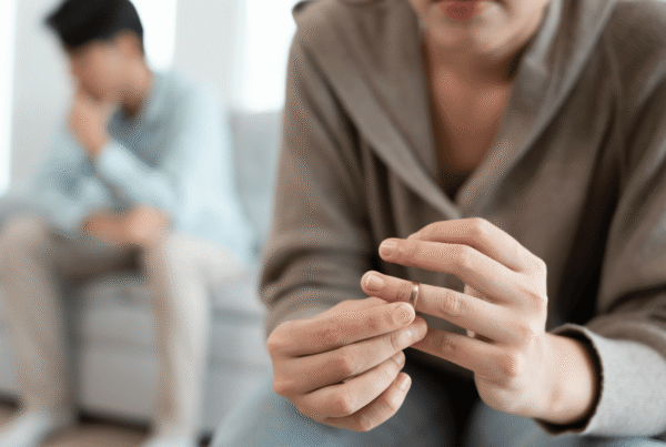 woman taking wedding ring off of her finger while talking to her husband about absolute divorce